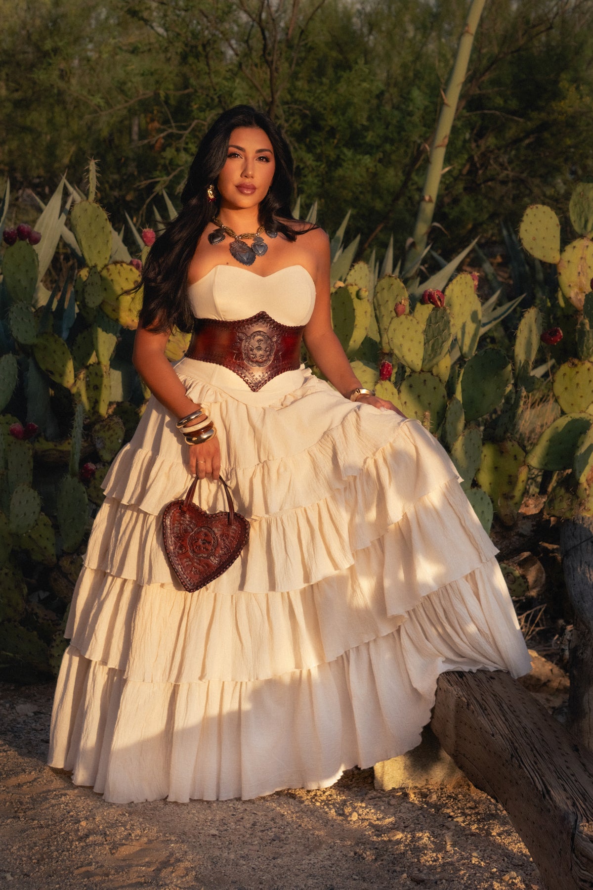 Model in a cream dress among desert cacti